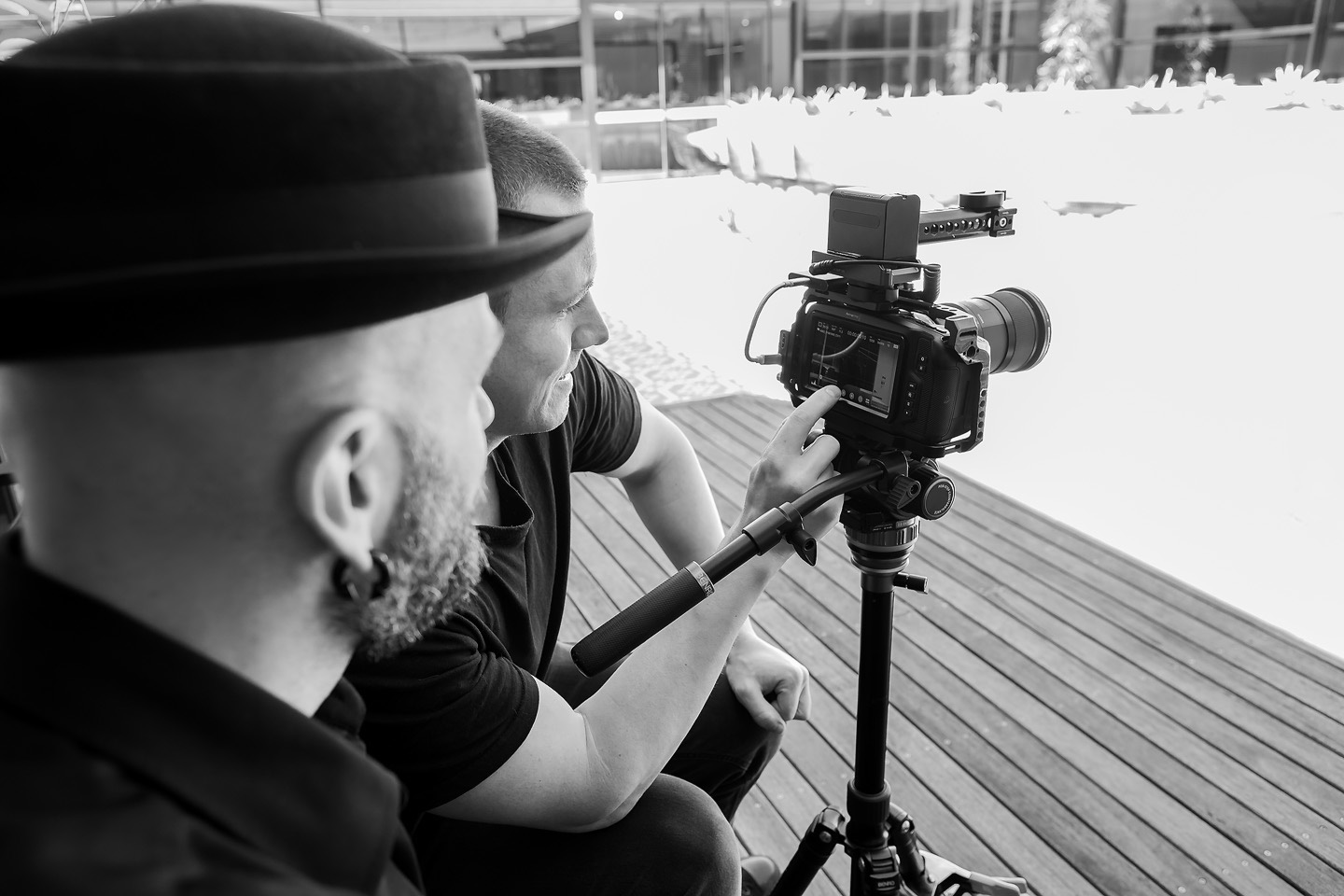 Two people checking the framing on a camera's rear screen