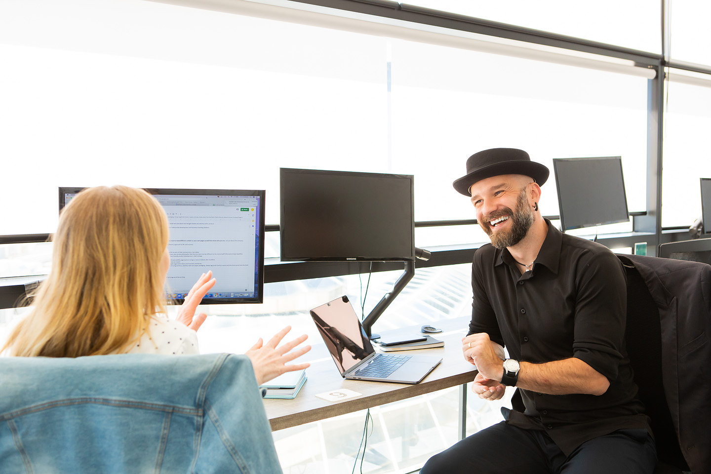 Arek Rainczuk working with a collaborator at a desk