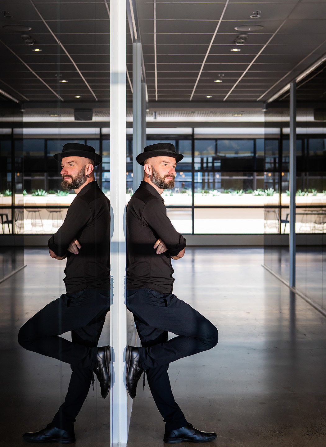 Arek Rainczuk, founder of Fifth Castle Media, reflected in glass