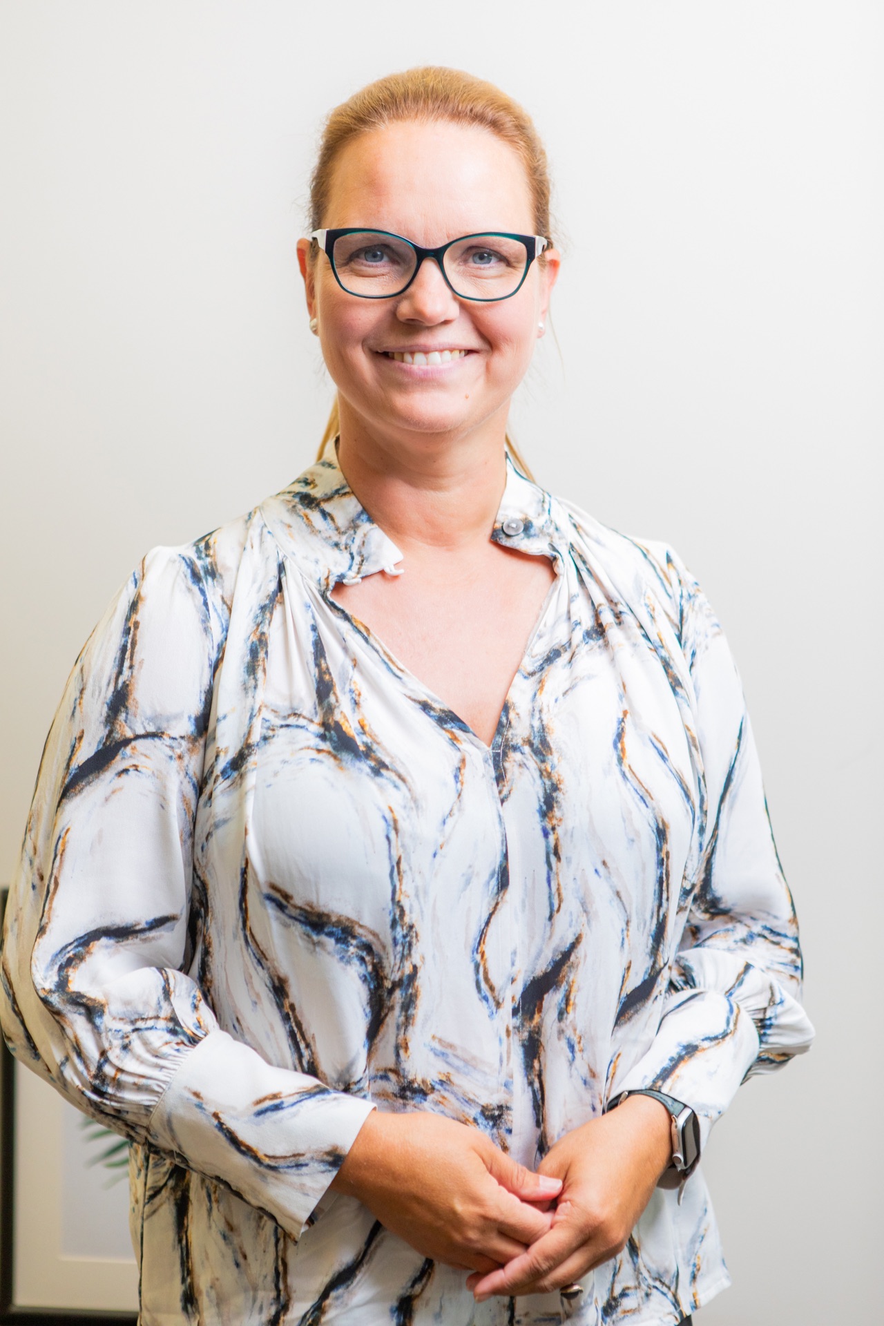 Studio headshot on a light background