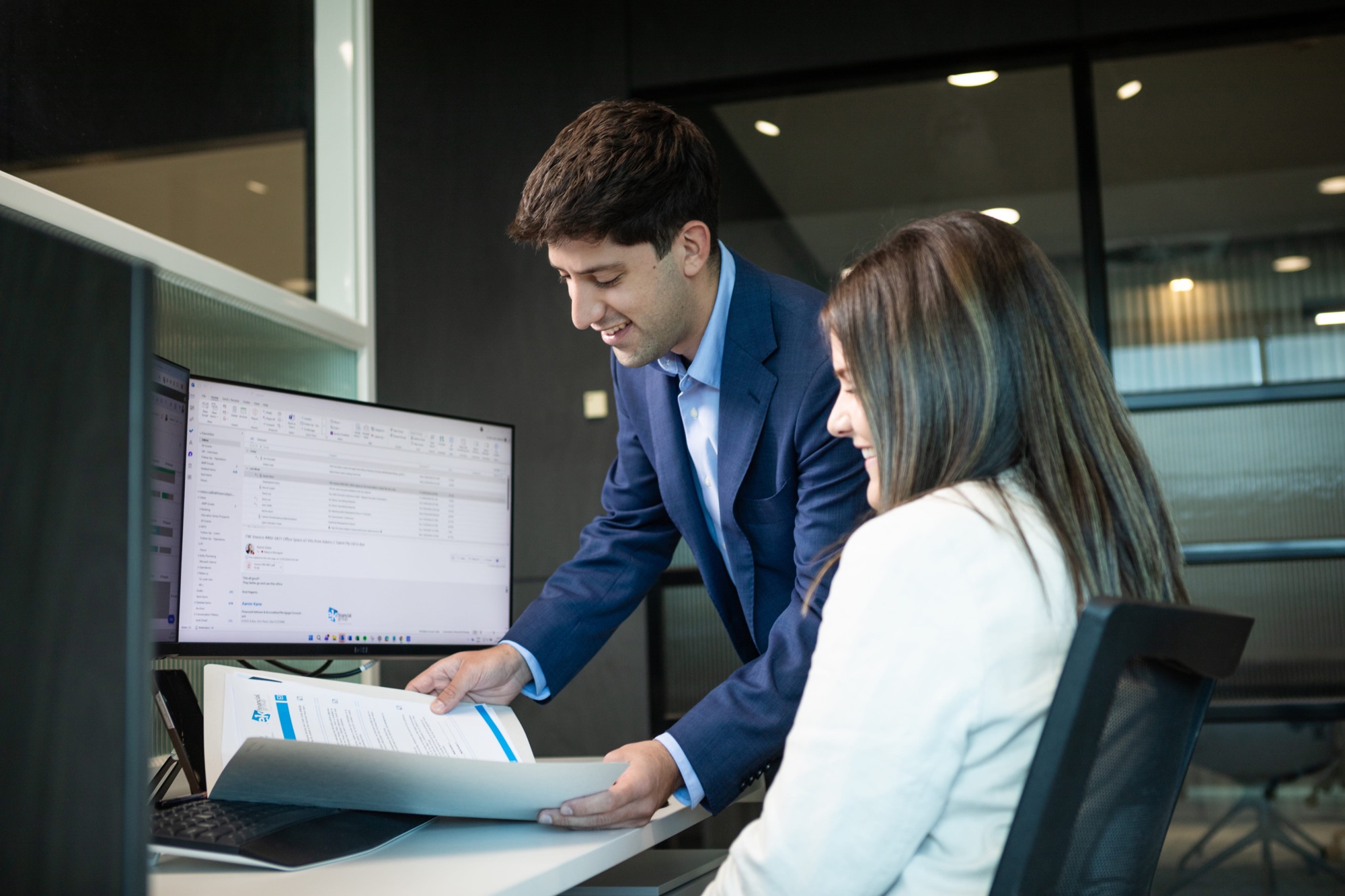 Colleagues at a standing desk at dusk