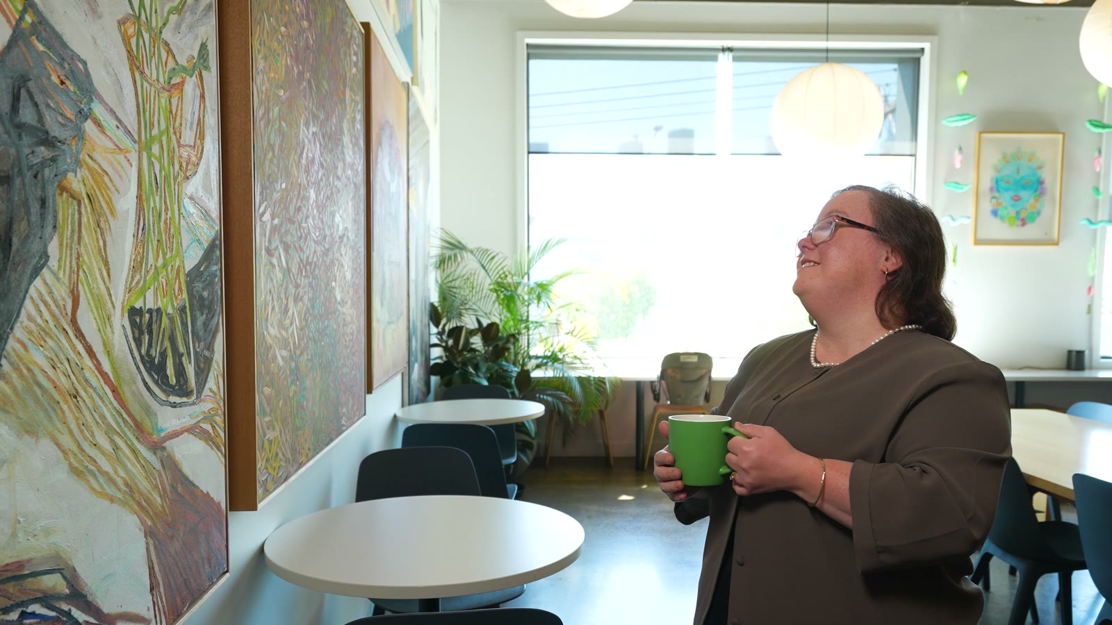 A woman smiling outside a building, from the Down Syndrome Australia film
